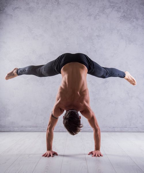 Man performing a controlled strength exercise in a minimalist setting.